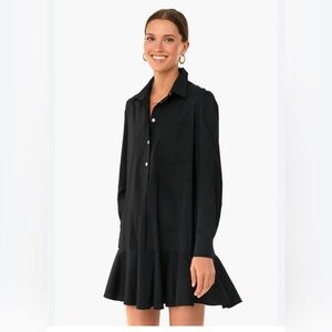 Tuckernuck Callahan black cotton shirt dress with a ruffled hem and pockets.